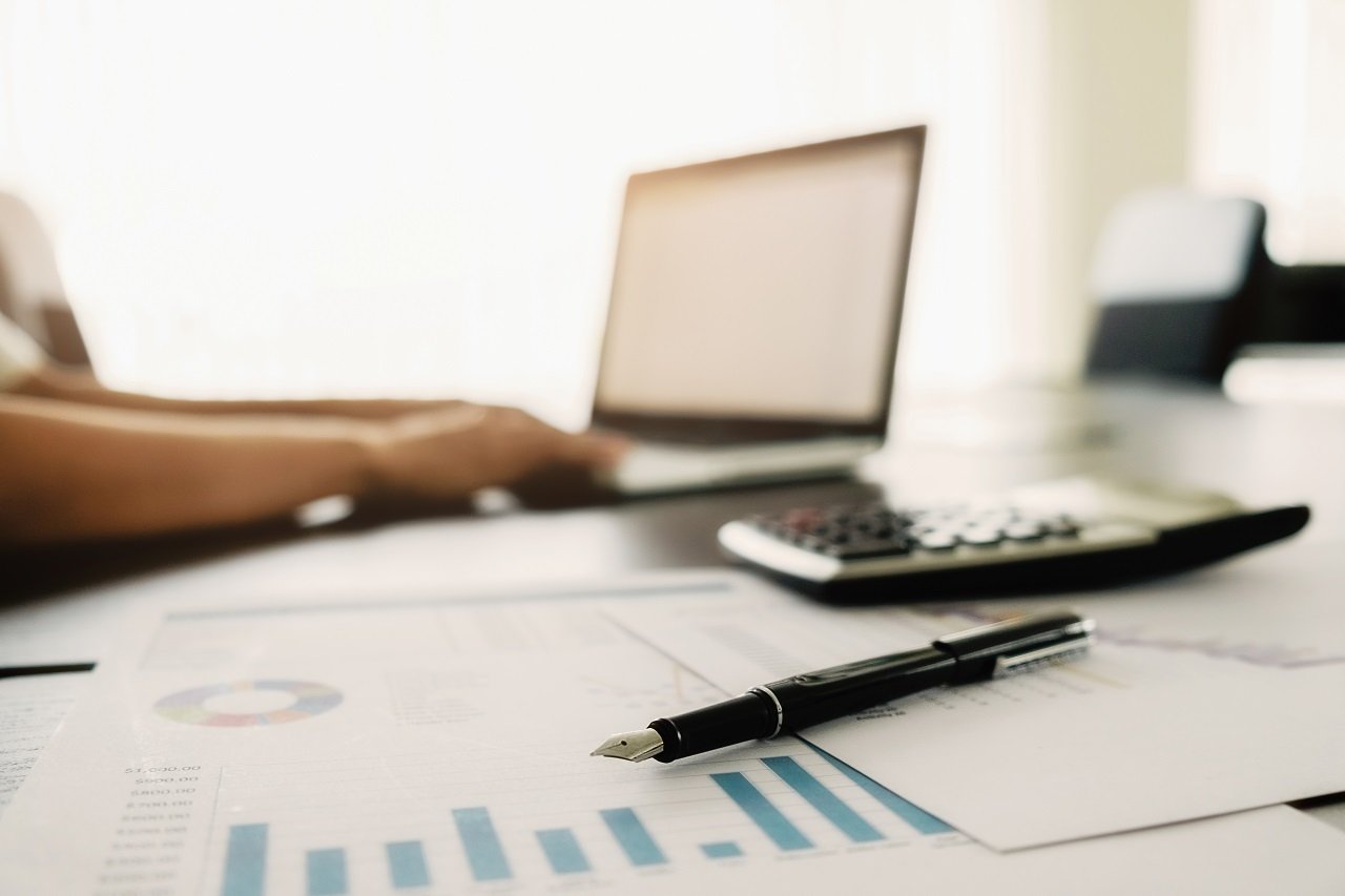 business-concept-with-copy-space-office-desk-table-with-pen-focus-analysis-chart-computer-notebook-cup-coffee-desk-vintage-tone-retro-filter-selective-focus